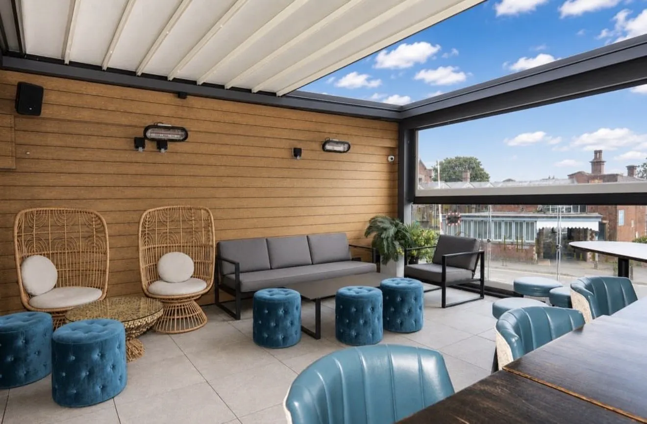 Lounge seating and velvet stools on the covered upstairs terrace