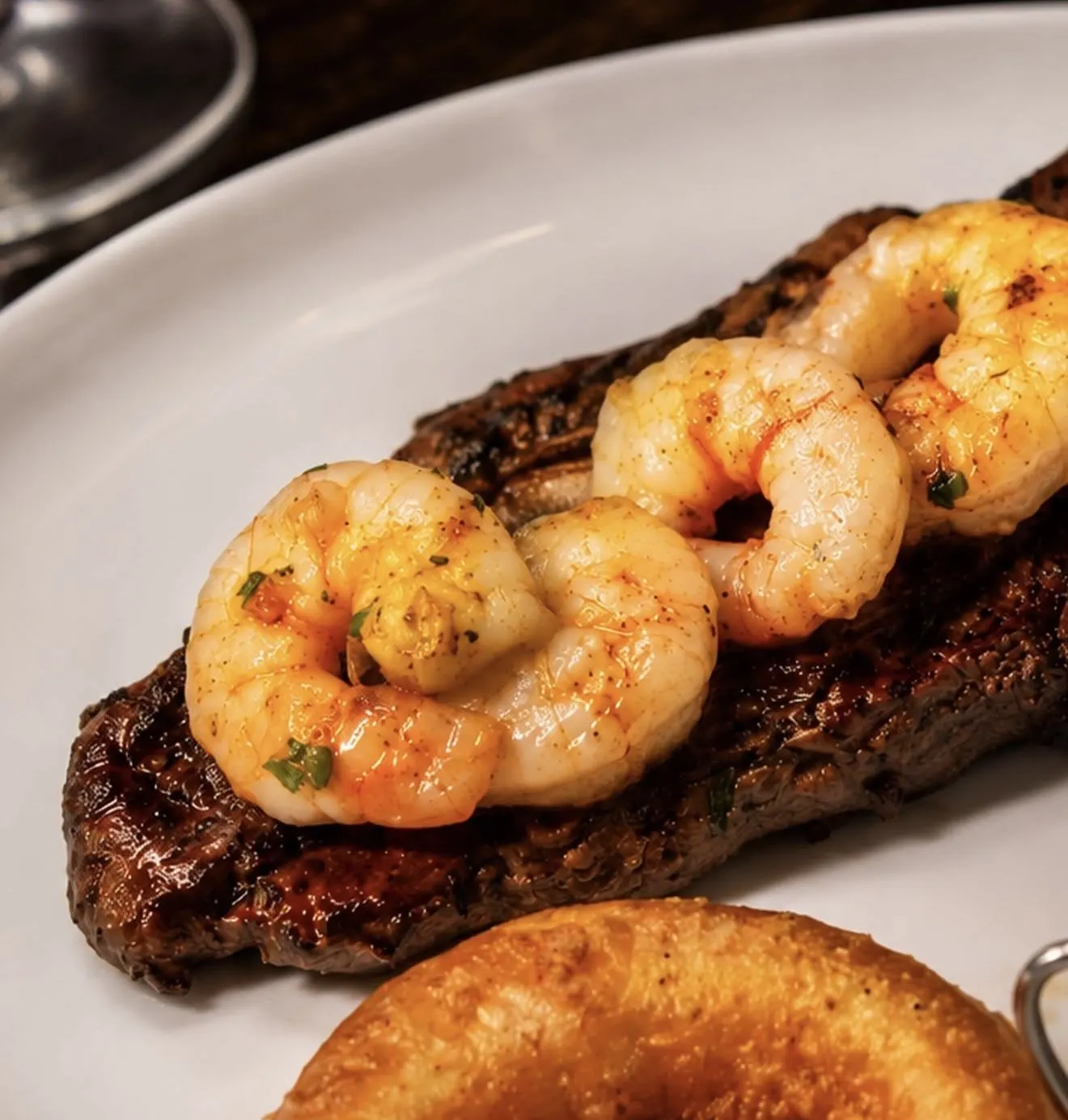 Sirloin topped with garlic king prawns